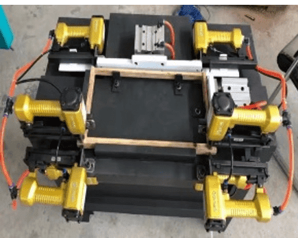 Industrial machine with multiple yellow pneumatic tools.