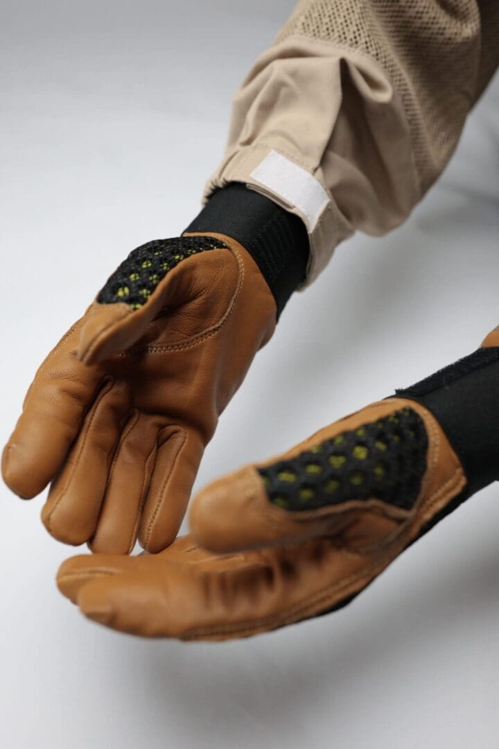 Brown gloves with black and green accents.