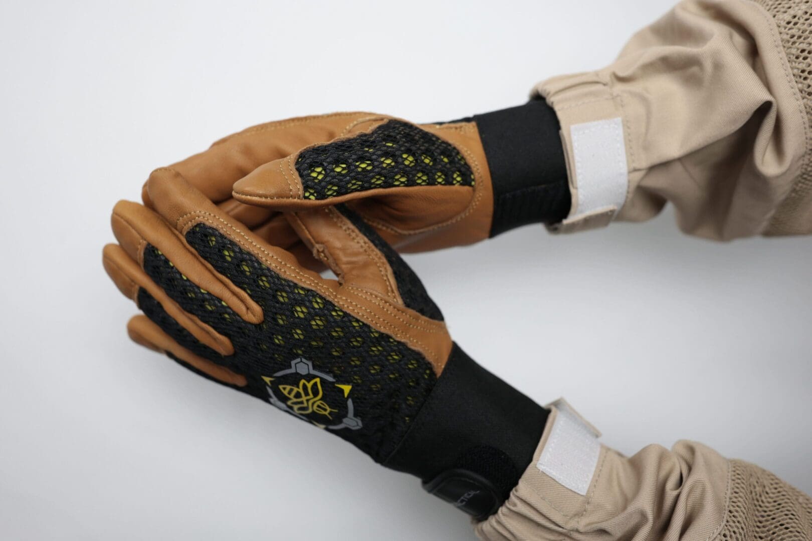 Protective gloves with mesh design and logo.